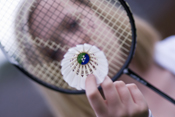 Picture of badminton player with racquet and shuttlecock  
